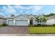 Light blue house with two-car garage and landscaped yard at 6282 Lakepine St, St Cloud, FL 34771