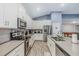 Open concept kitchen with stainless steel appliances and gray counters at 6282 Lakepine St, St Cloud, FL 34771