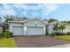 Light blue house with two-car garage and landscaped yard at 6282 Lakepine St, St Cloud, FL 34771