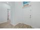 Light entryway with grey tile floors and white door at 6282 Lakepine St, St Cloud, FL 34771