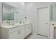 Double vanity bathroom with modern white cabinets and a large mirror at 6282 Lakepine St, Saint Cloud, FL 34771