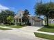 Two-story house with attached garage and landscaped yard at 4980 W Castle W St, Kissimmee, FL 34758
