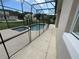 Screened-in pool and patio area with safety fence at 4980 W Castle W St, Kissimmee, FL 34758