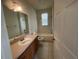 Simple bathroom with single sink vanity and tub at 4980 W Castle W St, Kissimmee, FL 34758