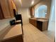 Kitchen with wood cabinets, black appliances, and tile floor at 4980 W Castle W St, Kissimmee, FL 34758