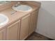 Double sink bathroom with light beige vanity and cabinets at 216 Balmoral Ct, Davenport, FL 33896