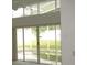 Living room with sliding glass doors opening to a view of the pool at 216 Balmoral Ct, Davenport, FL 33896
