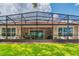 Screened patio and backyard with grassy lawn at 316 Treviso Dr, Poinciana, FL 34759