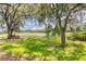 Peaceful backyard view of a golf course and trees at 316 Treviso Dr, Poinciana, FL 34759
