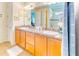 Double vanity bathroom with light beige tile floors and walls at 316 Treviso Dr, Poinciana, FL 34759