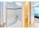 Clean bathroom with shower, tub, and toilet in a separate room at 316 Treviso Dr, Poinciana, FL 34759