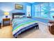 Blue bedroom with a comfortable bed and ample natural light at 316 Treviso Dr, Poinciana, FL 34759