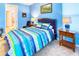 Serene bedroom with a queen bed, nightstands, and access to bathroom at 316 Treviso Dr, Poinciana, FL 34759