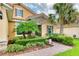 Front entrance with stone accents and tropical landscaping at 316 Treviso Dr, Poinciana, FL 34759