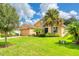 Two-story house with palm trees and a well-manicured lawn at 316 Treviso Dr, Poinciana, FL 34759