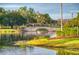 Stone bridge over lake with lush trees at 316 Treviso Dr, Poinciana, FL 34759