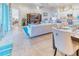 Spacious living room with comfortable seating and views to dining area at 316 Treviso Dr, Poinciana, FL 34759