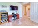 Home office includes a desk, chair, and ample storage for media and office supplies at 316 Treviso Dr, Poinciana, FL 34759
