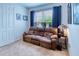 Cozy office features a brown leather reclining sofa, window with blinds, and a side table with a lamp at 316 Treviso Dr, Poinciana, FL 34759