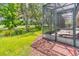 Screened patio with lounge chairs and access to the backyard at 316 Treviso Dr, Poinciana, FL 34759