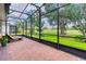 Relaxing screened patio with lounge chairs and view of the golf course at 316 Treviso Dr, Poinciana, FL 34759