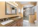 Updated bathroom with granite countertops, double sinks, and a walk-in shower at 117 Ridge View Dr, Davenport, FL 33837