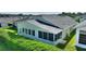 House back view with screened-in porch and partial view of the backyard at 117 Ridge View Dr, Davenport, FL 33837