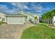 House exterior featuring a light green facade and a paved driveway at 117 Ridge View Dr, Davenport, FL 33837