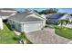 Aerial view of a light green house with a paved driveway and landscaped yard at 117 Ridge View Dr, Davenport, FL 33837