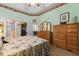 Main bedroom with floral bedding, a dresser, and access to the bathroom at 117 Ridge View Dr, Davenport, FL 33837