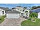 House exterior with a screened garage and landscaped yard at 117 Ridge View Dr, Davenport, FL 33837