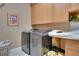 Laundry room with washer, dryer, and built-in cabinets at 19529 Dorr Rd, Altoona, FL 32702