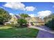 House exterior featuring solar panels, landscaping, and brick driveway at 19529 Dorr Rd, Altoona, FL 32702