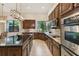 Spacious kitchen featuring granite countertops and stainless steel appliances at 203 Escondido Ct, Poinciana, FL 34759