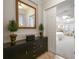 Entryway with console table and mirror reflecting bedroom at 203 Escondido Ct, Poinciana, FL 34759