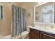 Clean bathroom with shower/tub combo and dark wood vanity at 203 Escondido Ct, Poinciana, FL 34759
