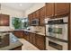 Kitchen with dark wood cabinets and granite countertops at 203 Escondido Ct, Poinciana, FL 34759