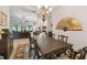 Elegant dining room with large table and chandelier at 203 Escondido Ct, Poinciana, FL 34759