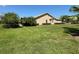 Large grassy backyard with lush landscaping at 203 Escondido Ct, Poinciana, FL 34759