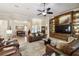 Open concept living room with leather furniture, built-ins, and views to the dining room at 203 Escondido Ct, Poinciana, FL 34759