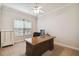 Spacious home office with large desk, window, and ceiling fan at 203 Escondido Ct, Poinciana, FL 34759