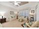 Main bedroom sitting area with sofas and ottoman at 203 Escondido Ct, Poinciana, FL 34759