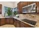 Kitchen boasts granite countertops and a corner window overlooking the outdoors at 203 Escondido Ct, Poinciana, FL 34759