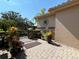 Charming courtyard entry with brick pavers and landscaping at 203 Escondido Ct, Poinciana, FL 34759