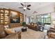 Living room with built-in entertainment center, leather sofas, and access to the lanai at 203 Escondido Ct, Poinciana, FL 34759