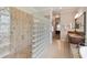 Large bathroom with walk-in shower, glass block wall, and neutral tile at 203 Escondido Ct, Poinciana, FL 34759
