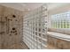 Bathroom with walk-in shower, glass block partition, and soaking tub at 203 Escondido Ct, Poinciana, FL 34759