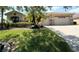 House exterior featuring stone accents, landscaping, and a three-car garage at 203 Escondido Ct, Poinciana, FL 34759