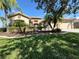 Beautiful home exterior with landscaping and a three-car garage at 203 Escondido Ct, Poinciana, FL 34759