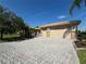 House with paver driveway and two-car garage at 203 Escondido Ct, Poinciana, FL 34759